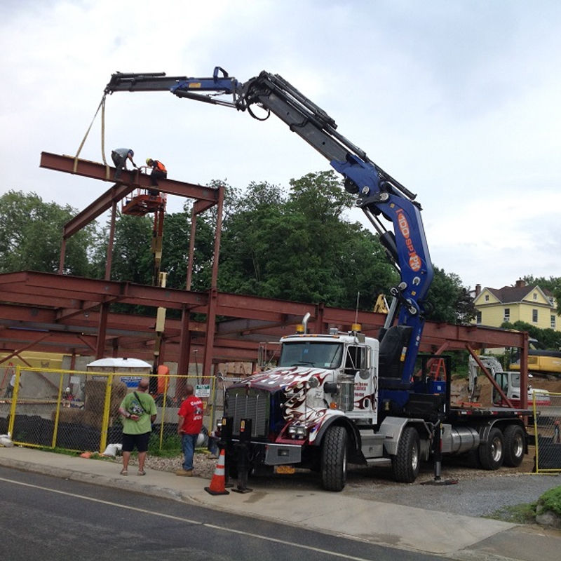 Boom crane lifting a heavy load above a NYC building